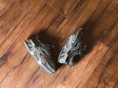 Pair of athletic shoes on a wooden floor.