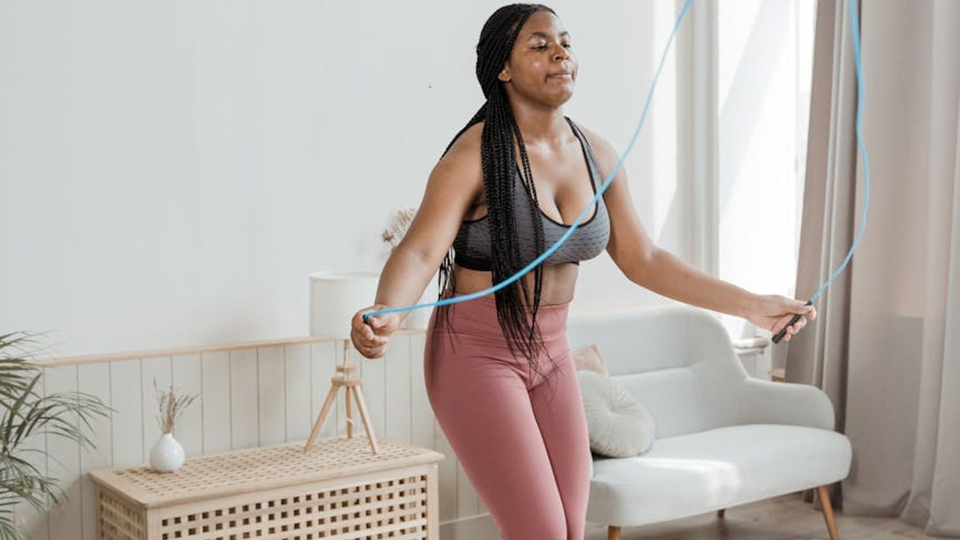 Person doing light cardio exercises in a bright room.